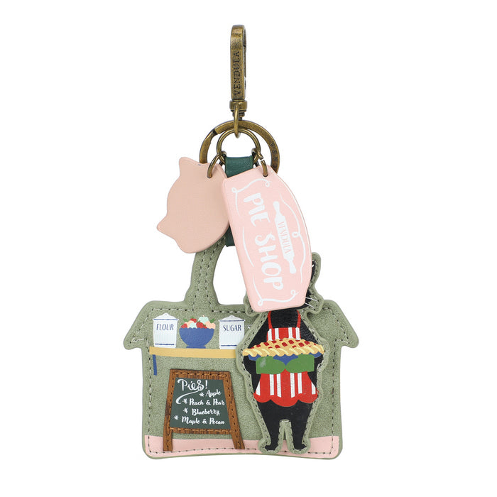 Keychain with a design of a person holding a pie, a piggy bank, and a sign on a white background.