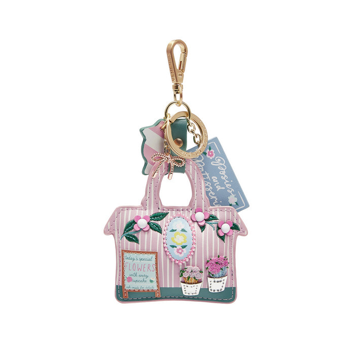 Keychain with a small house design and floral elements on a white background