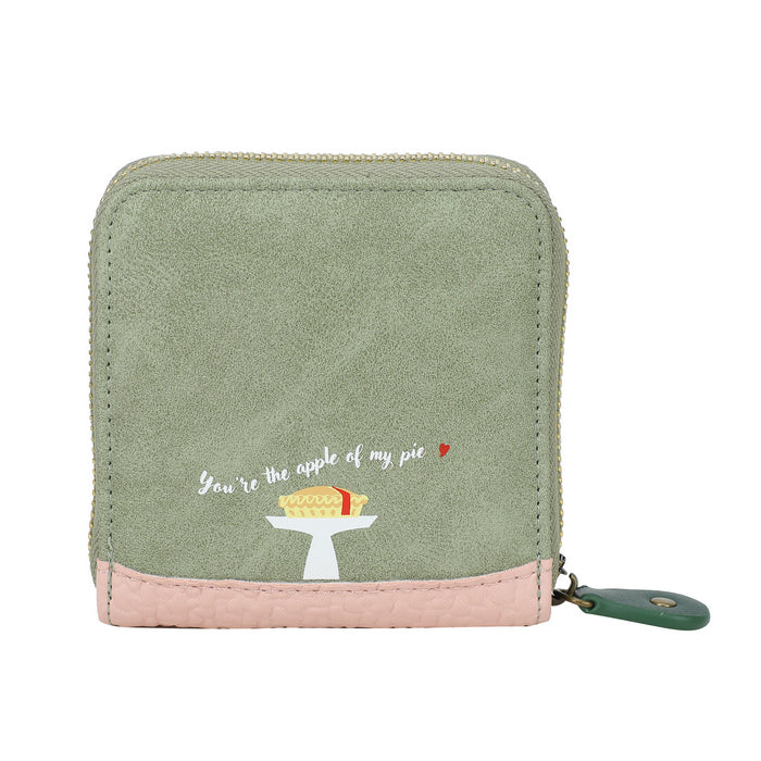 Green wallet with pink bottom section featuring an embroidered design and text on a white background
