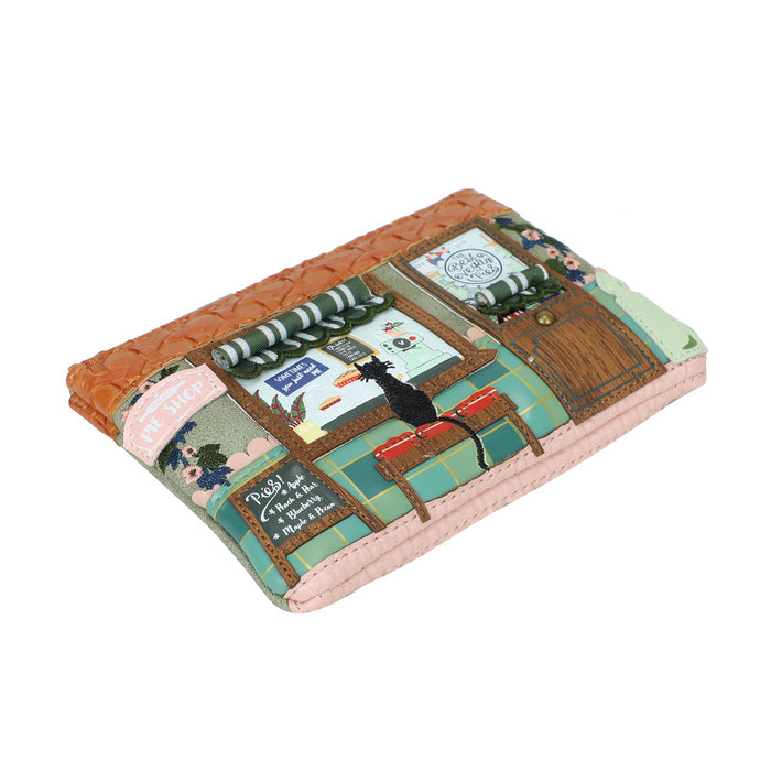 Small rectangular pouch with a quilted design featuring illustrations of a dog and various scenes on a white background.