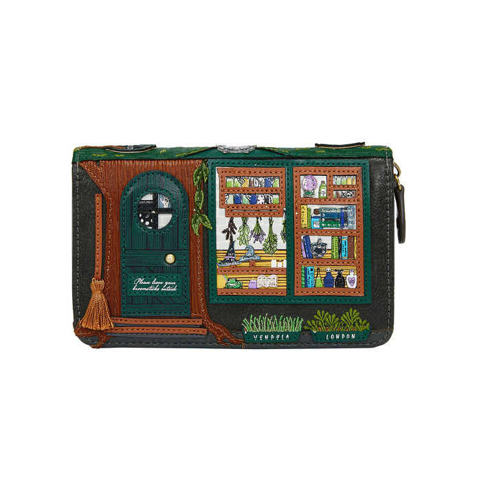 Wristlet with a design of a witch's shop window and door on a white background