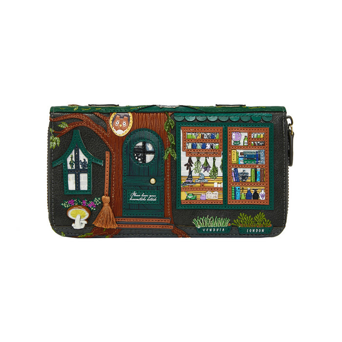 Handbag with a detailed design of a house and books on a white background