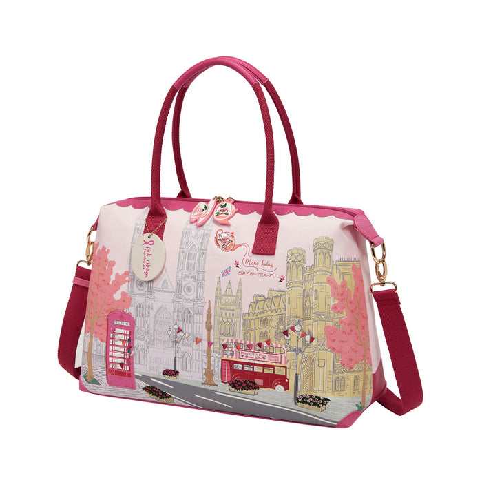 Handbag with cityscape design and pink accents on a white background