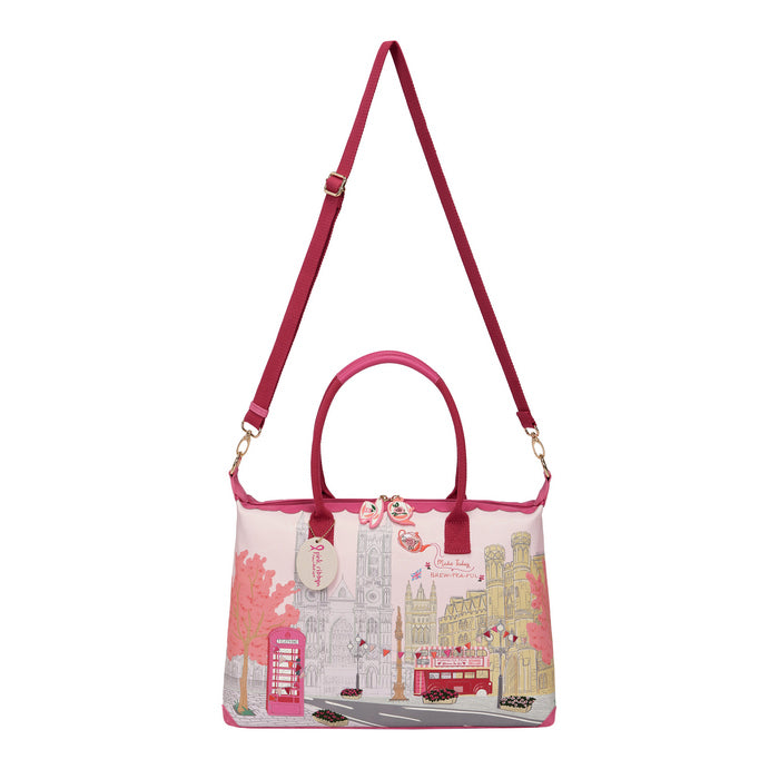 Pink handbag with cityscape design on a white background