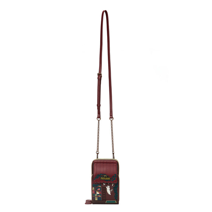 Brown crossbody bag with decorative elements on a white background