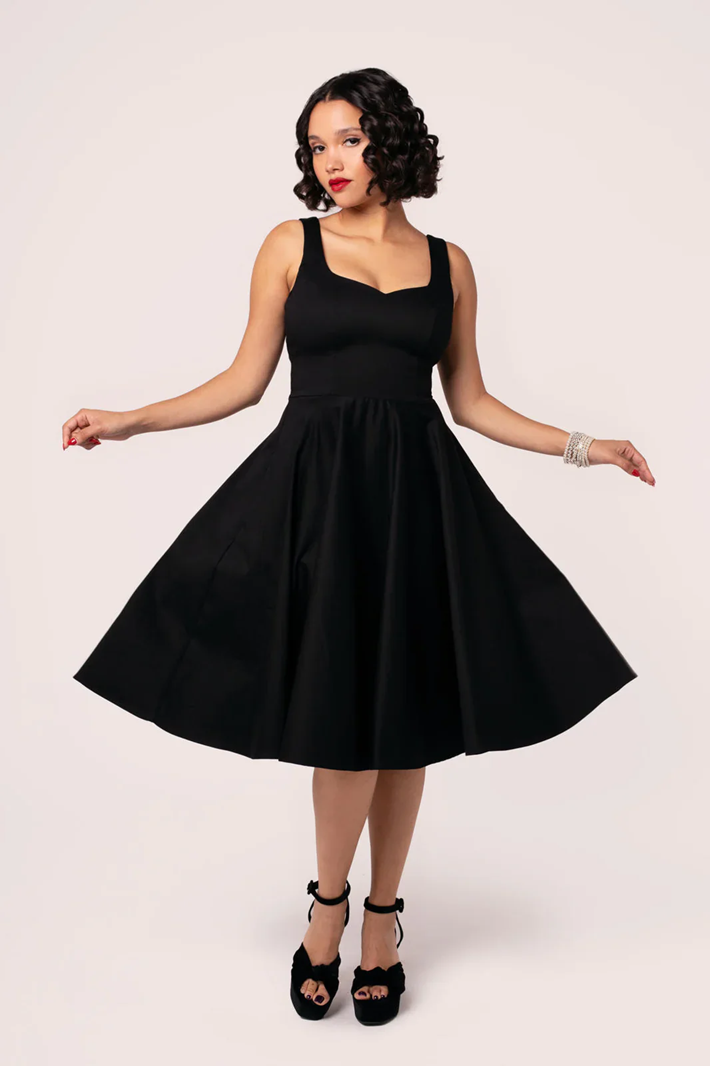 Woman wearing a black dress on a white background