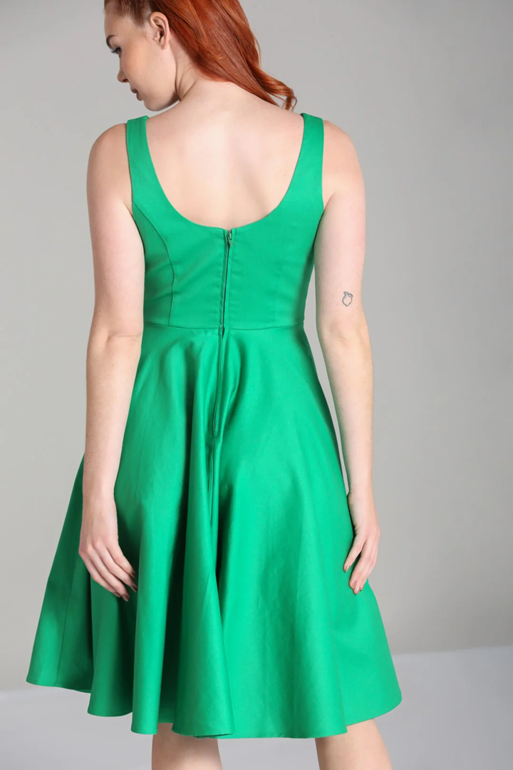 Green dress worn by a person on a gray background