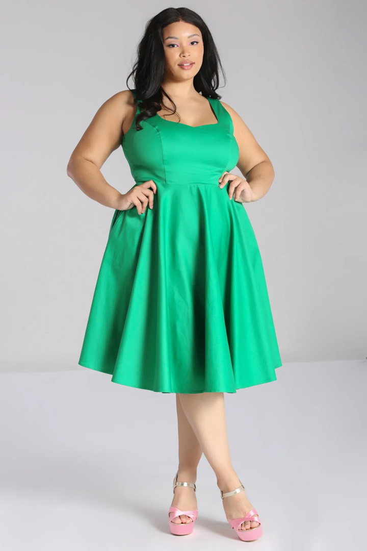 Woman wearing a green dress on a gray background