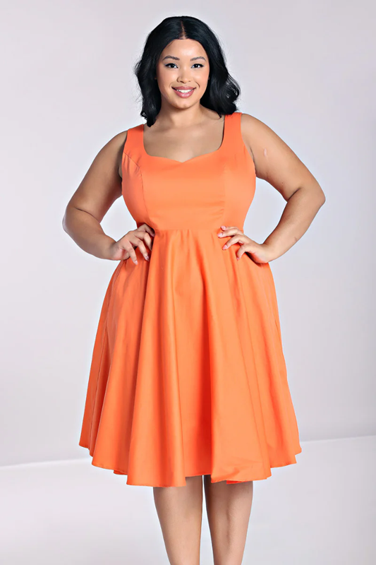 Woman wearing an orange dress against a white background
