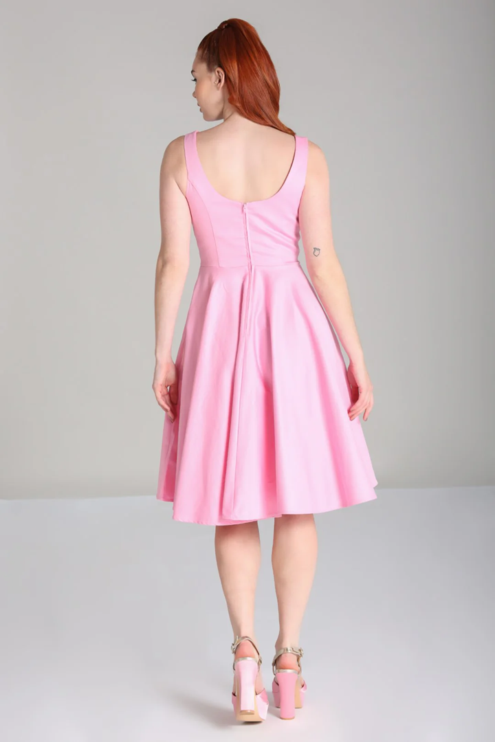 Woman wearing a pink dress on a gray background