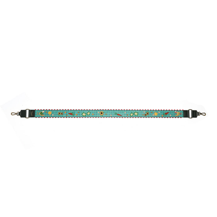 A horizontal strap featuring a turquoise blue background with a repeating pattern of small embroidered flowers and leaves in yellow, green, and orange. The strap has black plastic hardware on both ends with silver metal hooks.