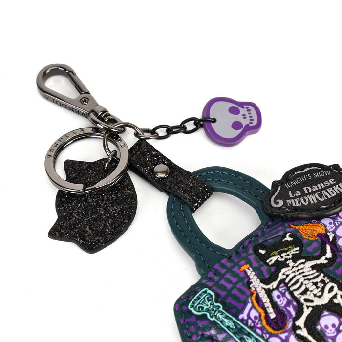 A Halloween-themed keychain bag set featuring a purple and black patterned tote bag with a skeleton design, a black glitter cat-shaped charm, a silver clasp, and a small purple skull tag on a white background.