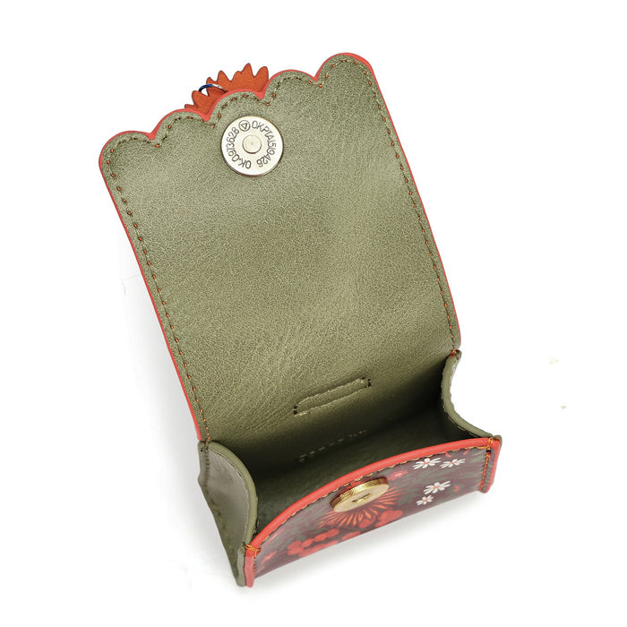 An open leather card holder or case with an olive green interior, red-orange exterior trim, and a decorative floral pattern on the lower flap. A round silver-tone metal button is visible on the inside flap.
