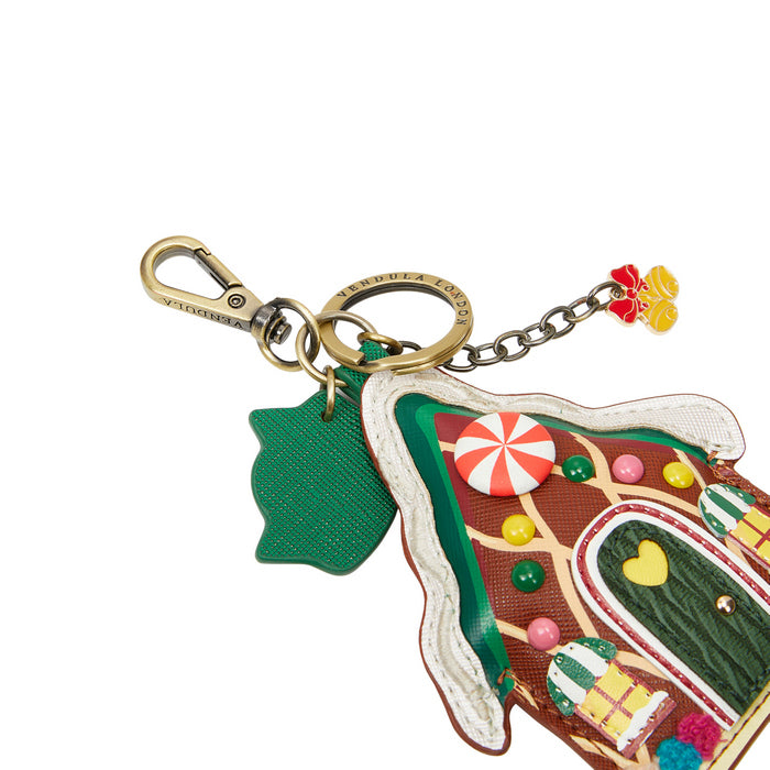 Colorful gingerbread house keychain with candy decorations on a white background