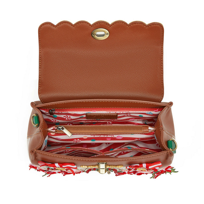 Open brown leather handbag with colorful interior lining on a white background