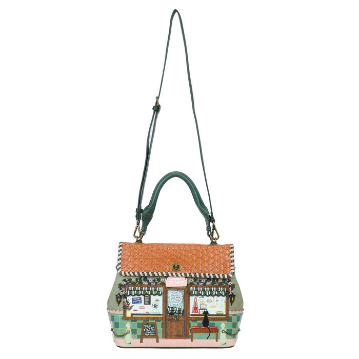 Handbag with a design of a quaint store front on a white background