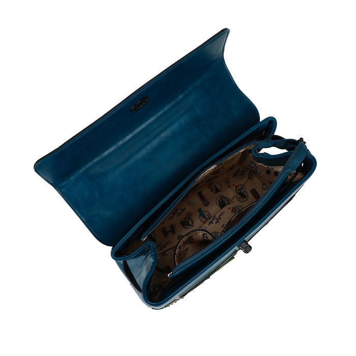 Blue clutch bag with patterned interior on a white background