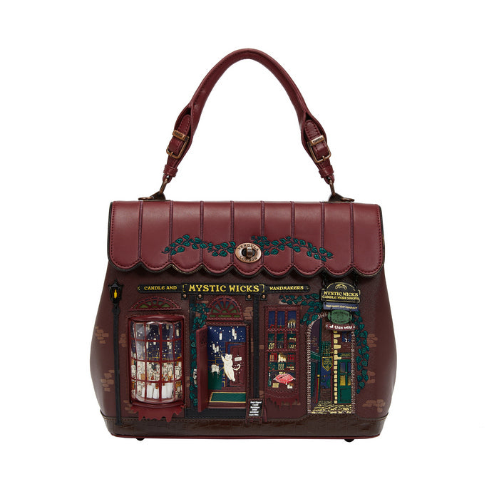 Brown handbag with decorative design on a white background
