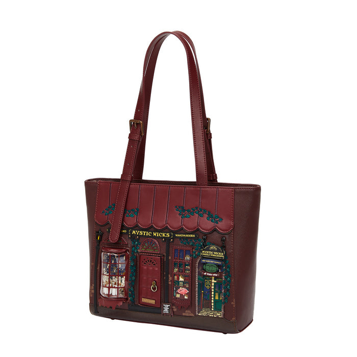 Brown leather tote bag with decorative design on a white background