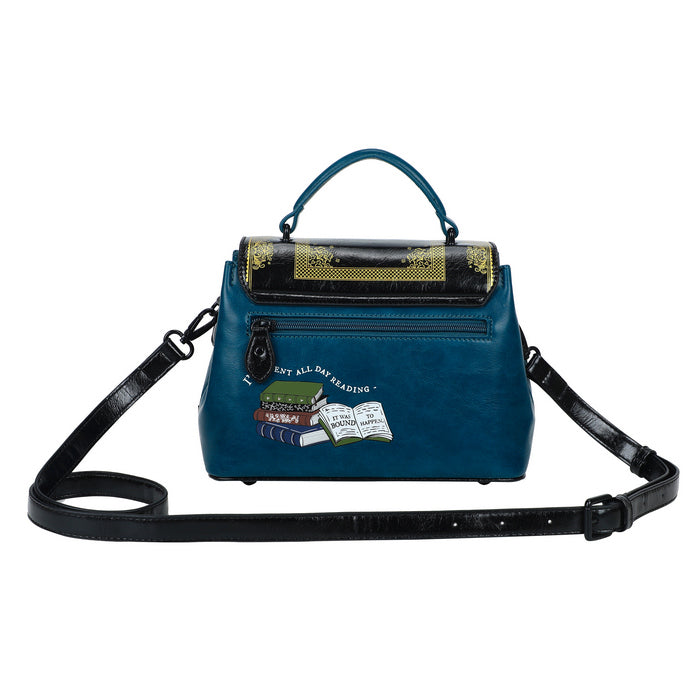 Blue handbag with book-themed patches on a white background