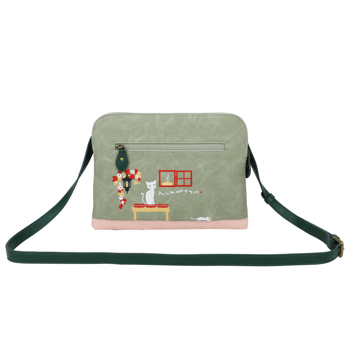 Green crossbody bag with cat-themed design on a white background