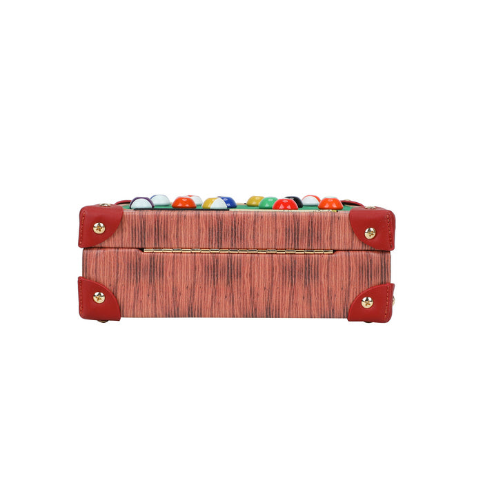 Wooden box with red leather straps and colorful marbles on a white background