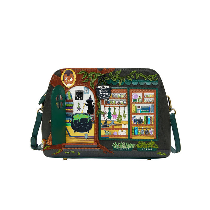 Colorful handbag with witch-themed design on a white background