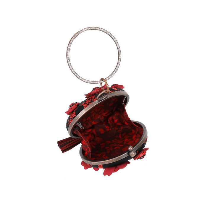 Decorative keychain with red and black design on a white background
