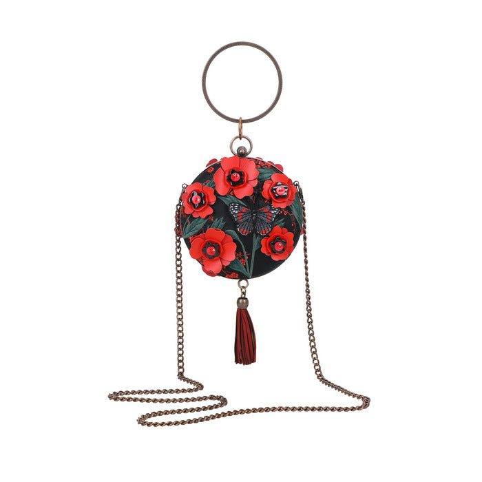 Decorative keychain with floral design and tassel on a white background