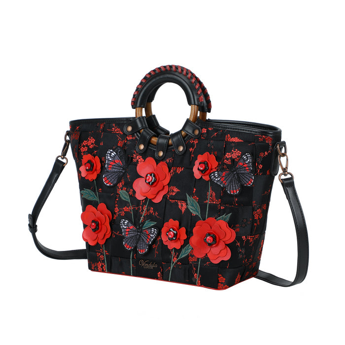 Black handbag with red floral pattern on a white background
