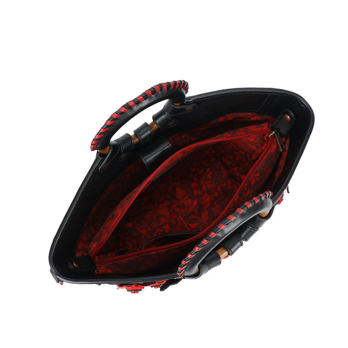 Black and red leather handbag with a unique design on a white background