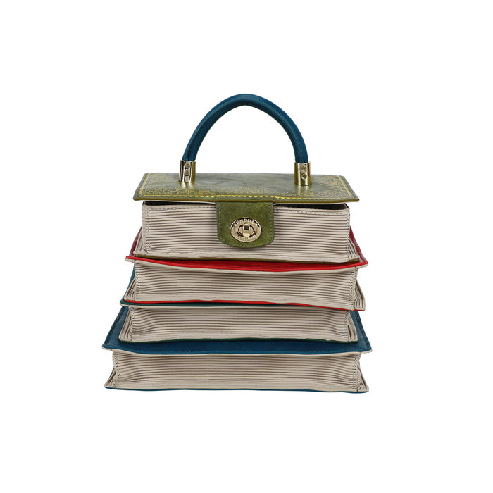 Stack of books shaped like a handbag with a visible brand emblem on a white background
