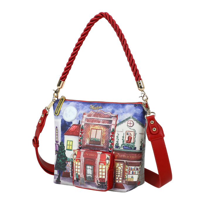 Handbag with a colorful design of buildings and a red handle on a white background