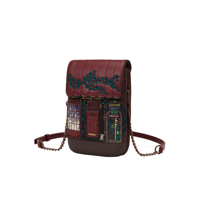 Brown leather crossbody bag with decorative embossing on a white background