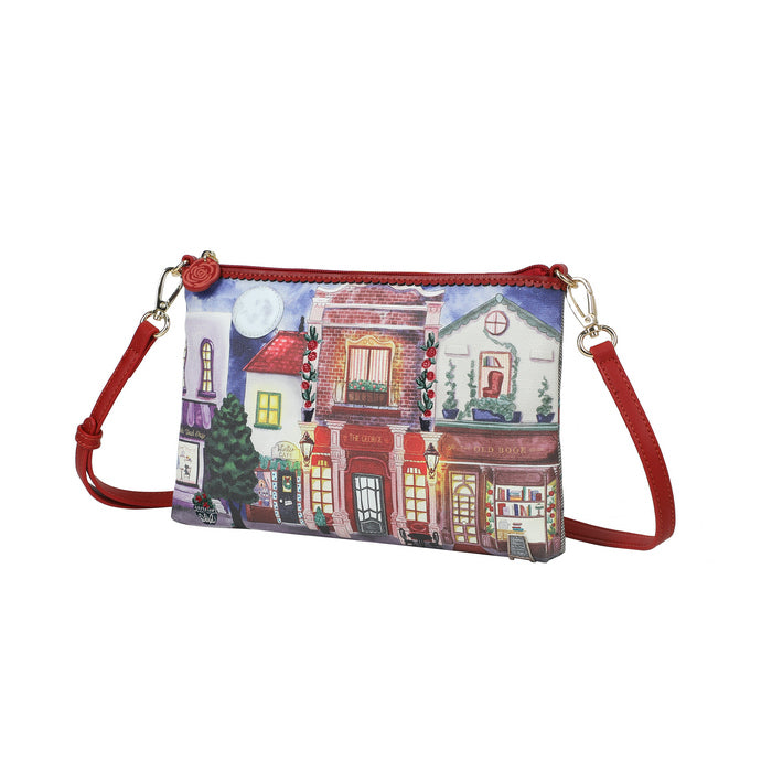Crossbody bag with a festive village design on a white background