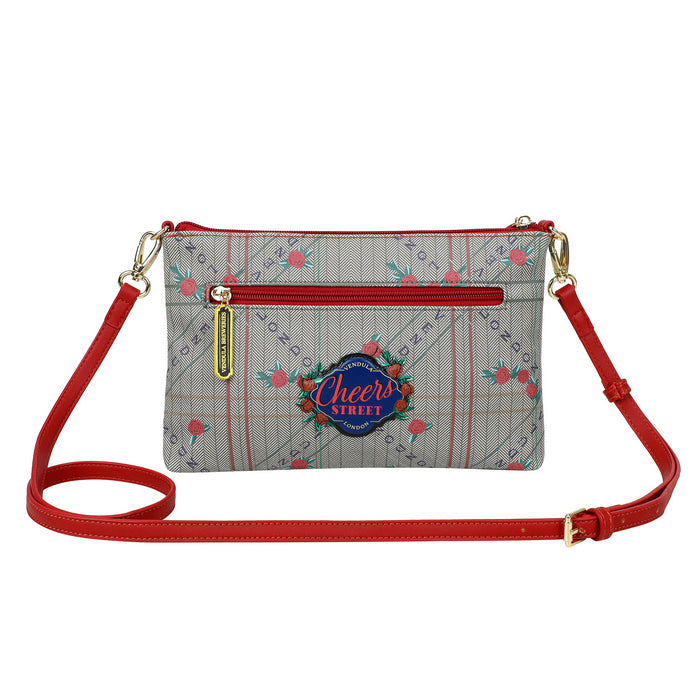 Crossbody bag with red strap and floral pattern on a white background