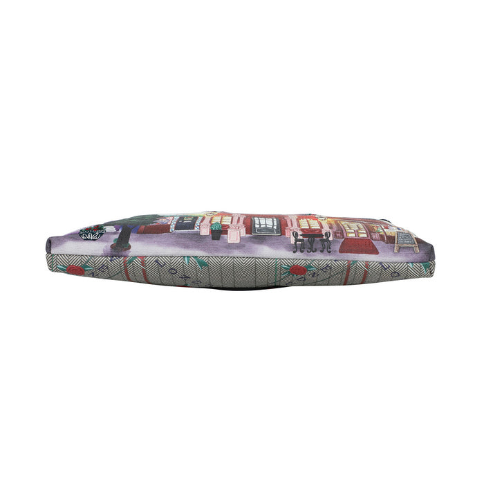 Dog bed with a colorful street scene design on a white background