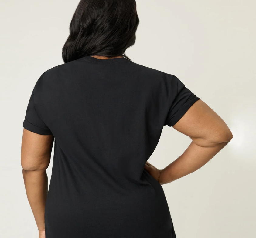 Person wearing a black t-shirt against a plain background