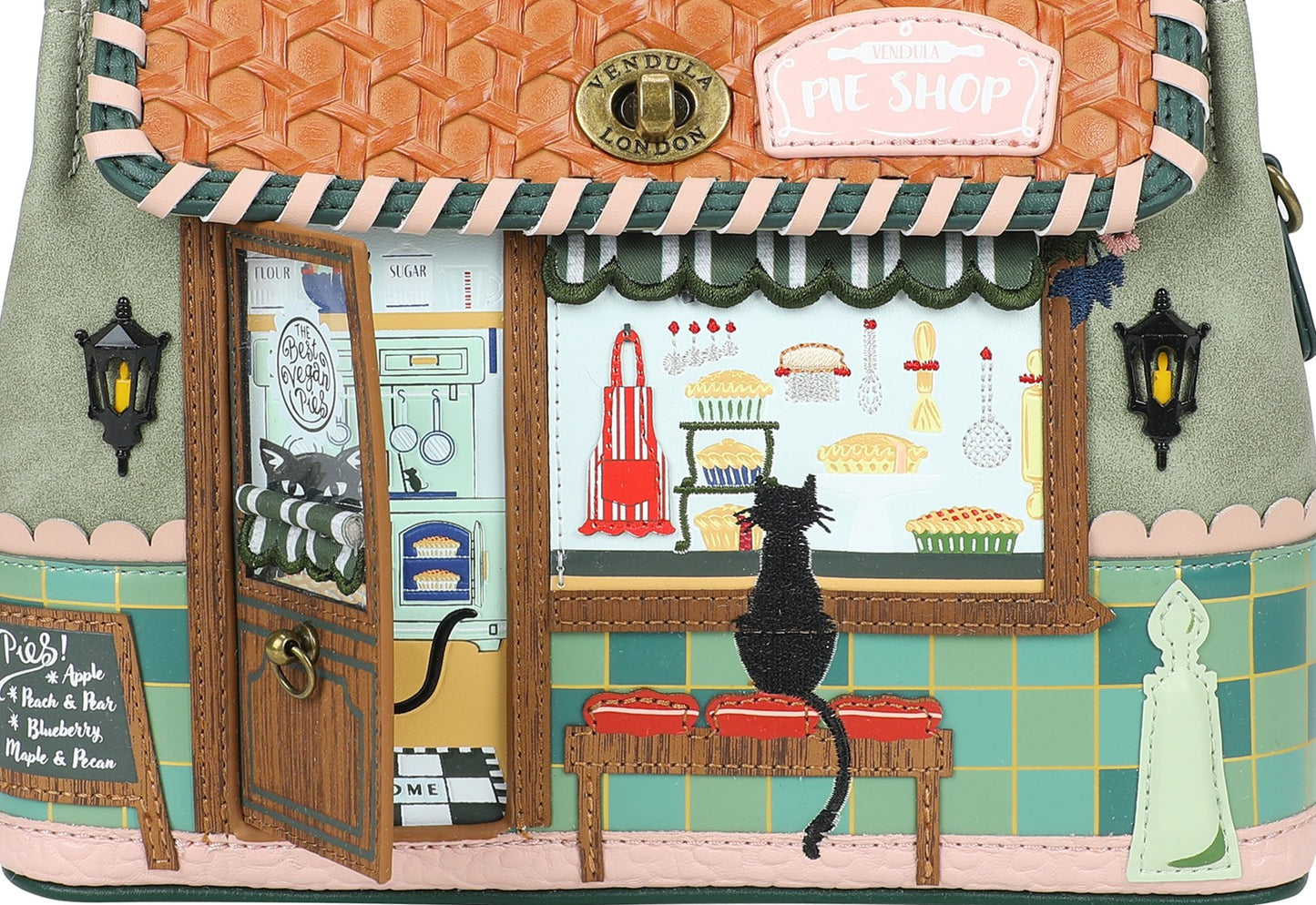 Handbag designed like a vintage pet shop with a cat inside, featuring detailed interior illustrations.