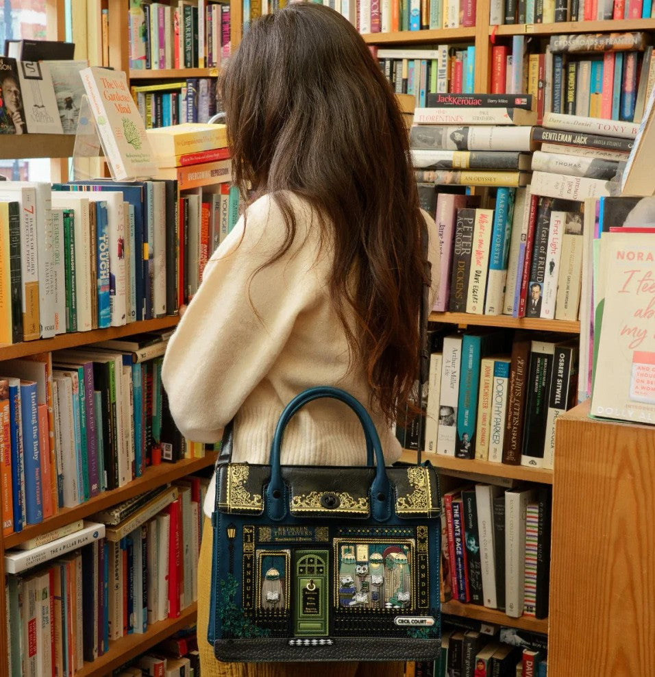 Woman with a decorative handbag in a bookstore