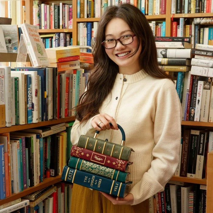 Woman holding books in a library setting