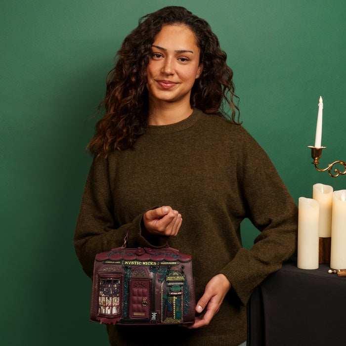 Woman holding a decorative bag with candles and a candlestick in the background