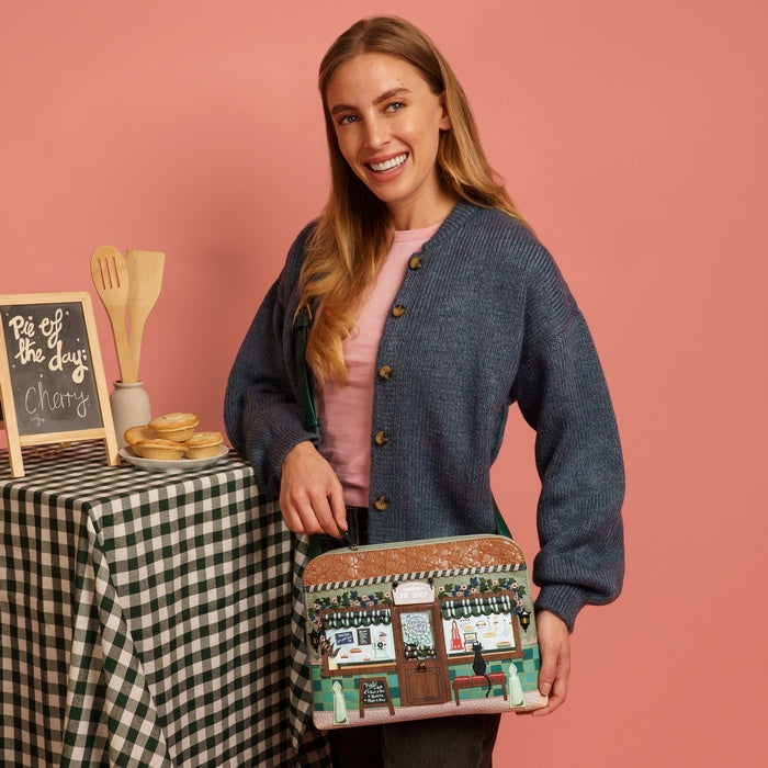 Woman holding a patterned bag with a pink background