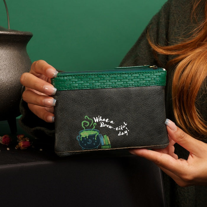 Person holding a black pouch with green zipper and 'What a Brew-iful Day!' text and design.