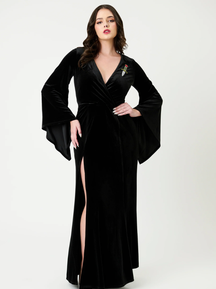 Woman wearing a black evening gown with a high slit on a white background