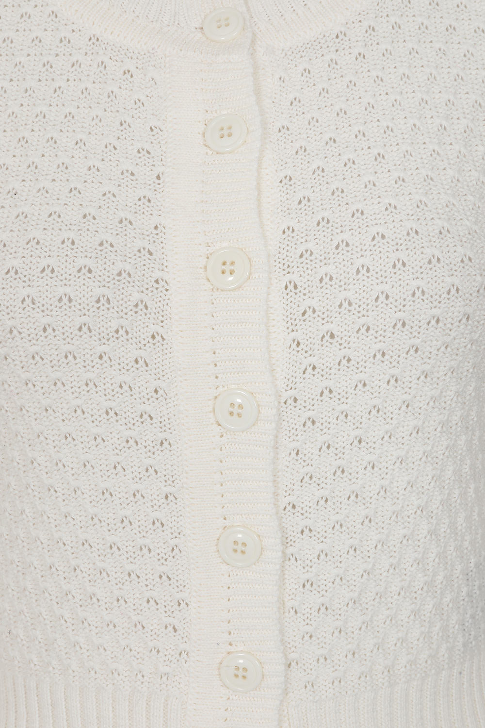 Close-up of a textured white cardigan with button details