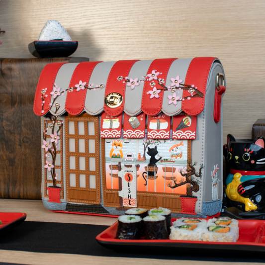 Handbag designed like a sushi restaurant with cherry blossoms and a cat illustration.