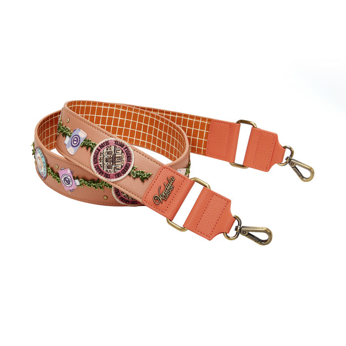 Peach-colored strap with decorative elements on a white background
