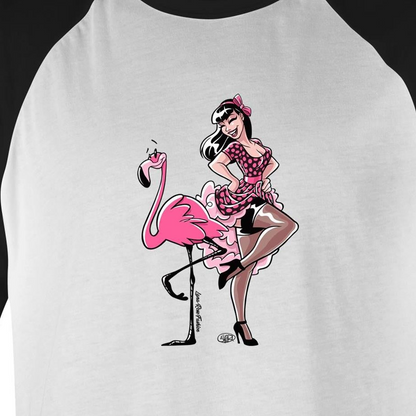 A white raglan baseball t-shirt featuring a retro-style graphic of a pin-up girl sitting on a pink flamingo. The shirt has black raglan sleeves and a black collar, with the graphic printed on the front.