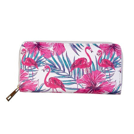 A zip-around wallet featuring a vibrant tropical print of pink flamingos, pink hibiscus flowers, and teal palm leaves on a white background, with a gold-tone zipper and pull tab.
